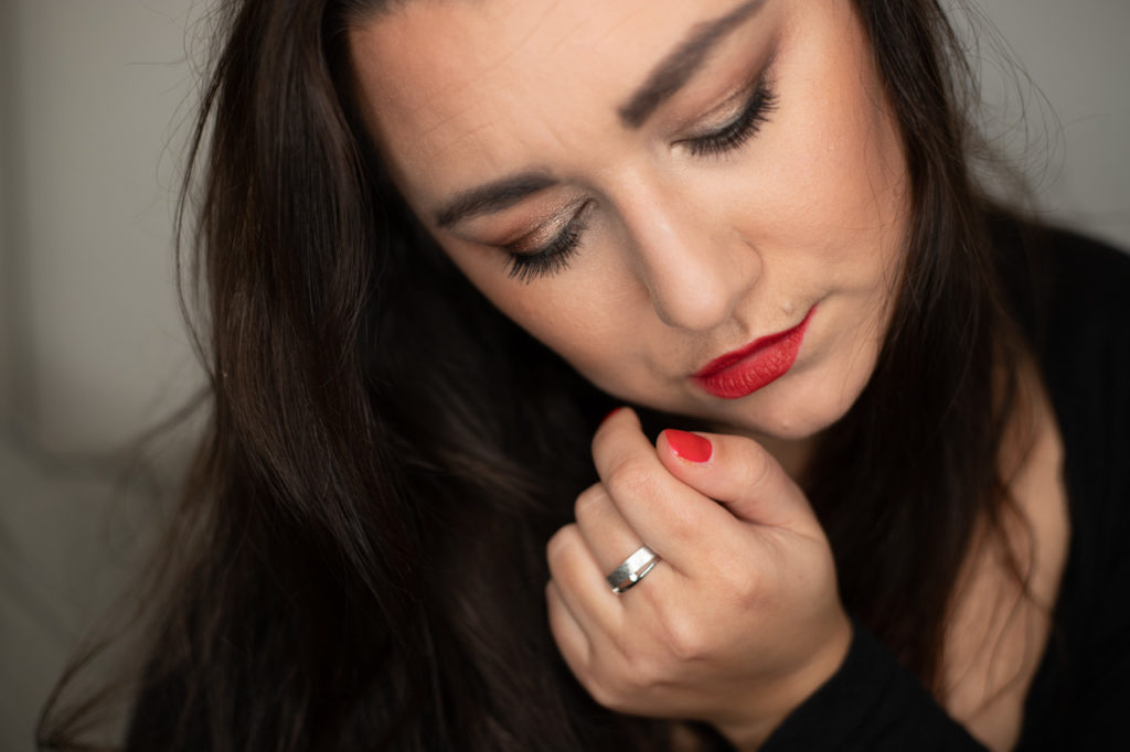 Schöne Frau mit tollen Make Up und roten Lippen. Schöner Ring im Mittelpunkt.